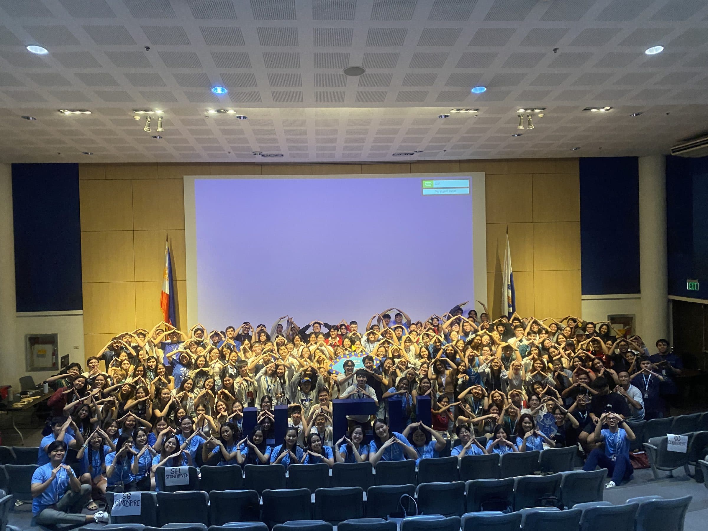 Chapter members and students at a campus assembly