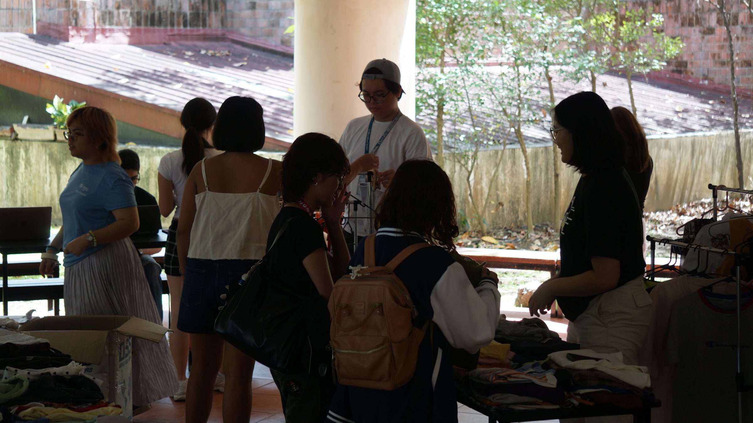 Students browsing tables and racks of donated clothes