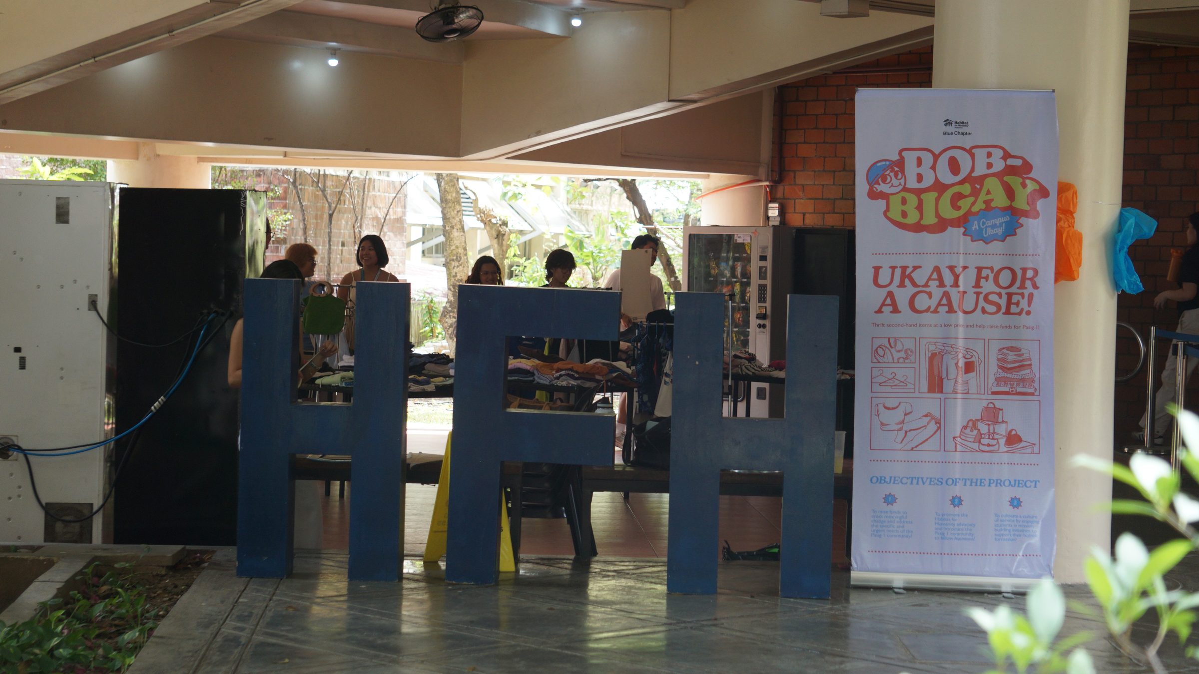 The Bob-Bigay stall on campus, with tables of donated clothes and a “Ukay for a cause” banner