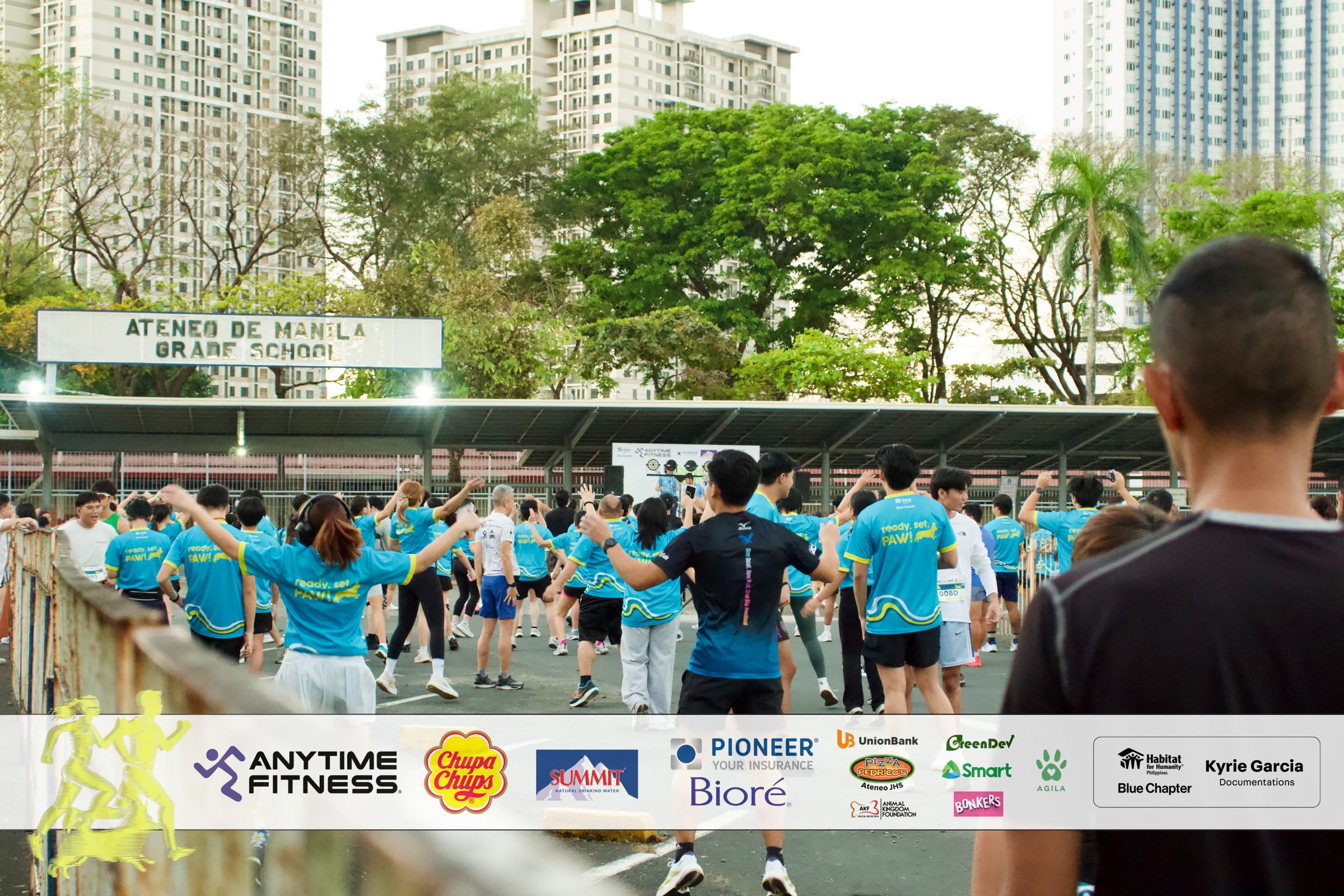 Runners warming up together on the Ateneo grade school grounds before the run